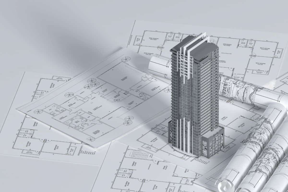 Architect drawing a home floor plan with pencil and ruler