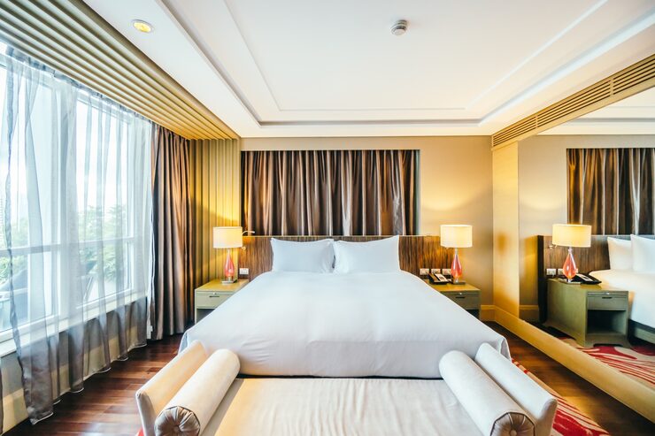 Bright bedroom with large windows, representing a residence layout